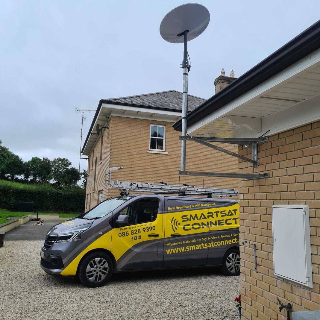 starlink antenna installed on a house with a Smart Sat Connect van in the background