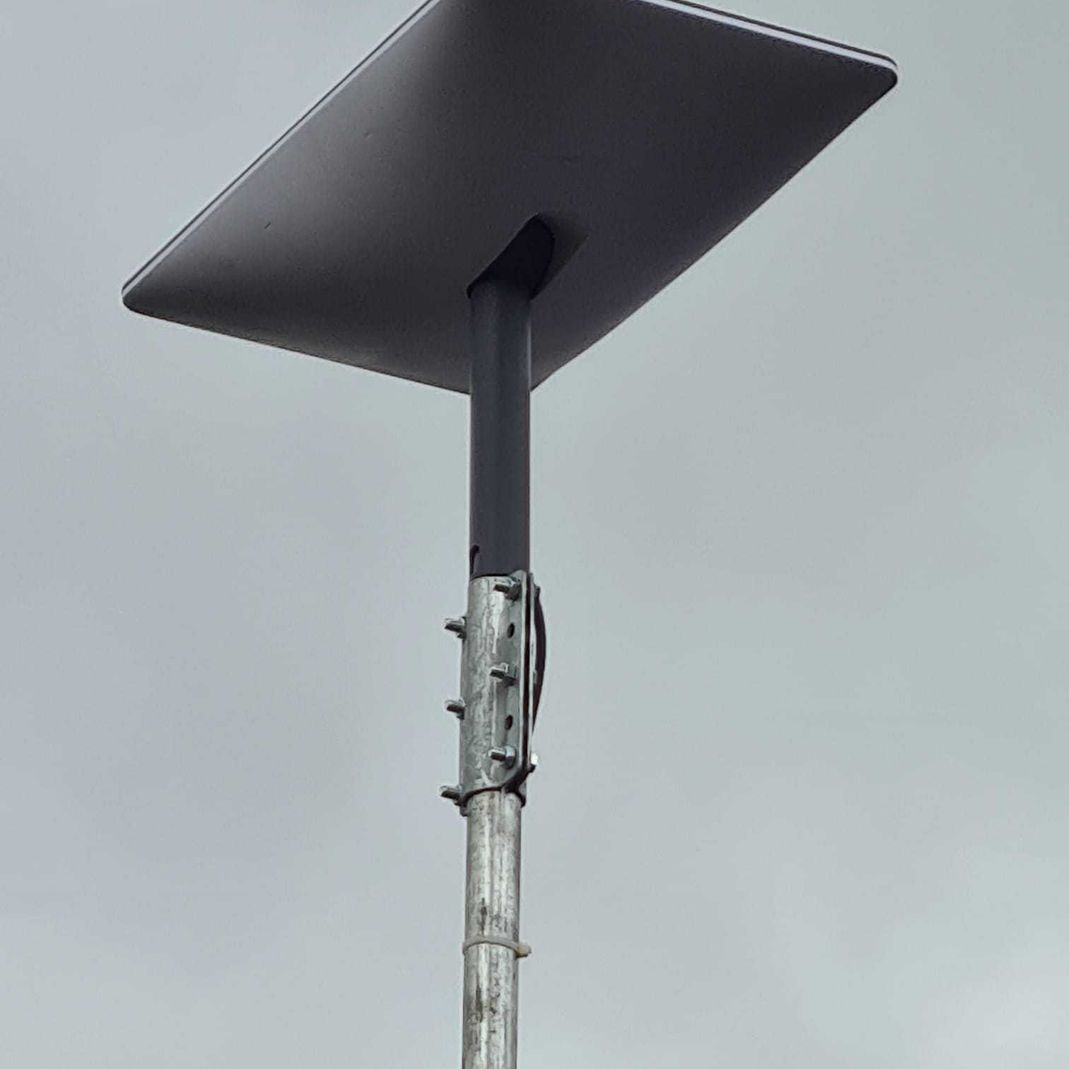 starlink antenna against a cloudy sky